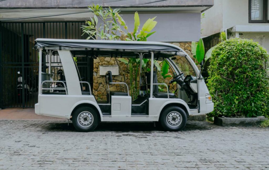 Electric tourist car or Shuttle bus white waiting in the park.