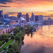 Aerial cityscape image of downtown St. Paul, Minnesota, USA with reflection of the skyline in Mississippi River at beautiful summer sunrise.